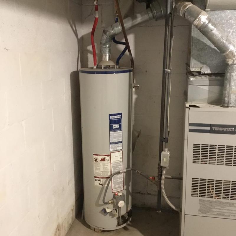 Gas water heater installed with connected supply lines Gas water heater installed with connected supply lines