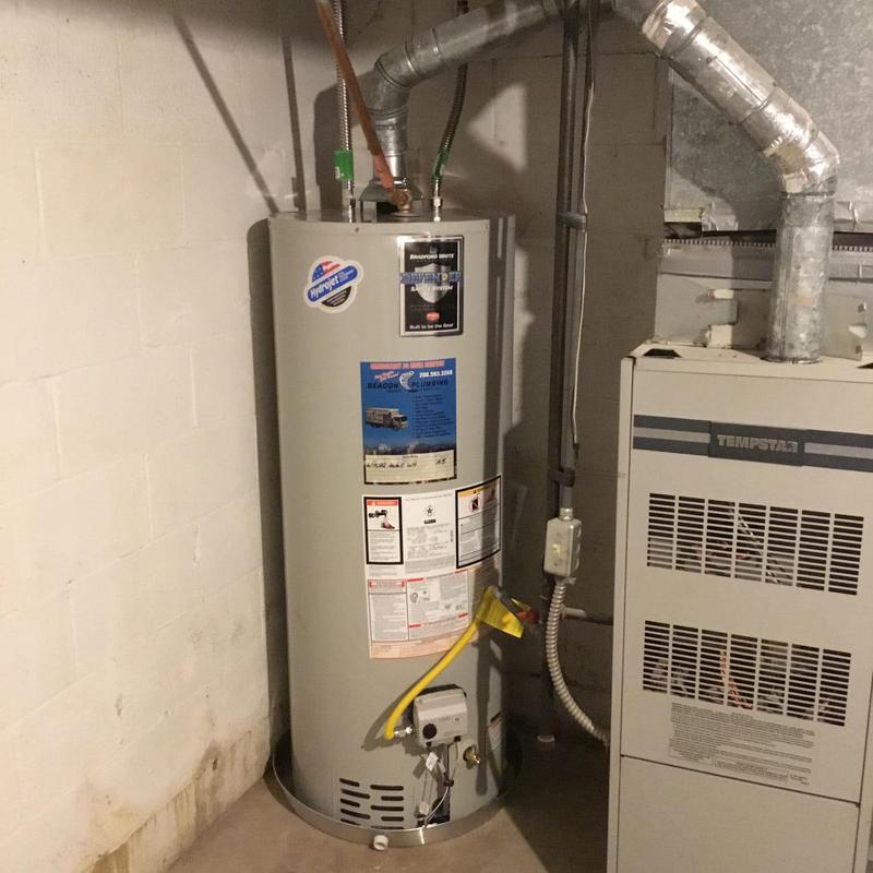 Gas water heater installation with new piping and drip pan Gas water heater installation with new piping and drip pan
