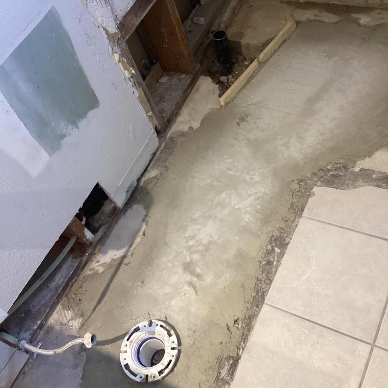 Bathroom floor plumbing excavation with toilet flange installed Bathroom floor plumbing excavation with toilet flange installed