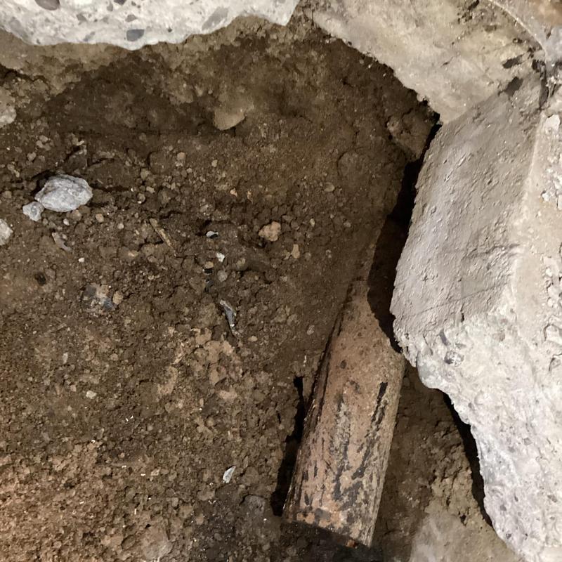 Cast iron sewer line exposed under concrete floor Cast iron sewer line exposed under concrete floor
