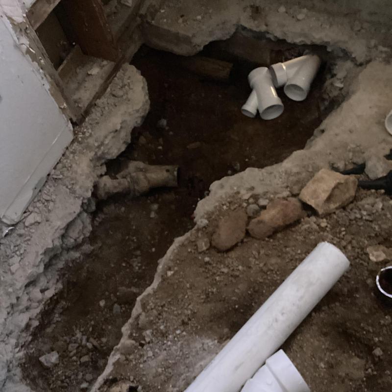 Bathroom sewer line excavation with PVC fittings and cast iron pipe Bathroom sewer line excavation with PVC fittings and cast iron pipe
