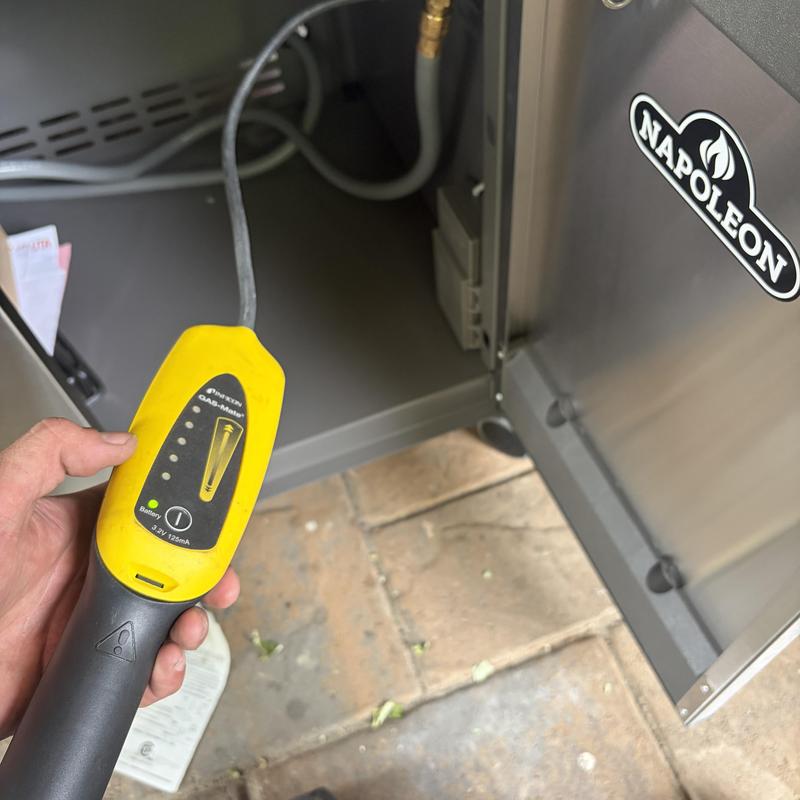 Barbecue grill gas leak detector in use