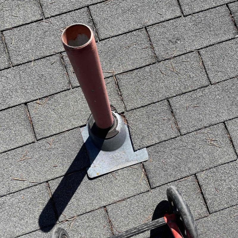 Orangeburg pipe with root intrusion on roof shingles Orangeburg pipe with root intrusion on roof shingles