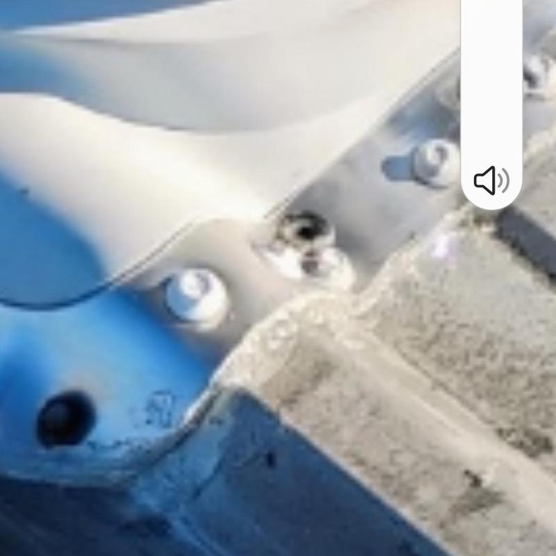 Metal roofing hail damage with fastener close-up