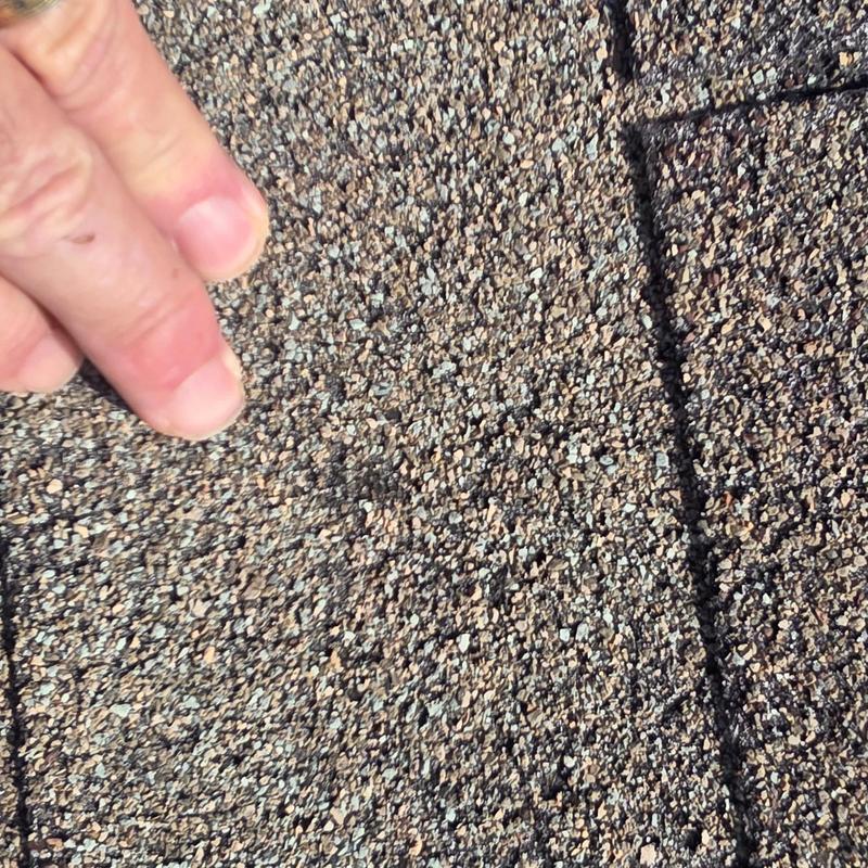 Asphalt shingles with hail impact damage close-up