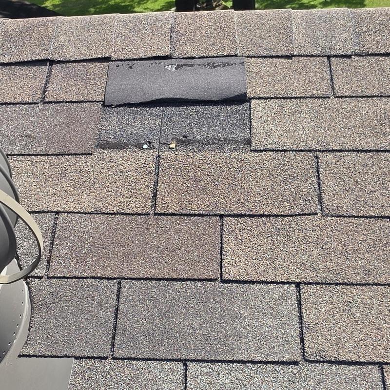 Roof shingles with hail damage and patch in Terrell, TX