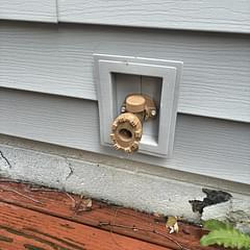 Hose bib with access installed on house exterior