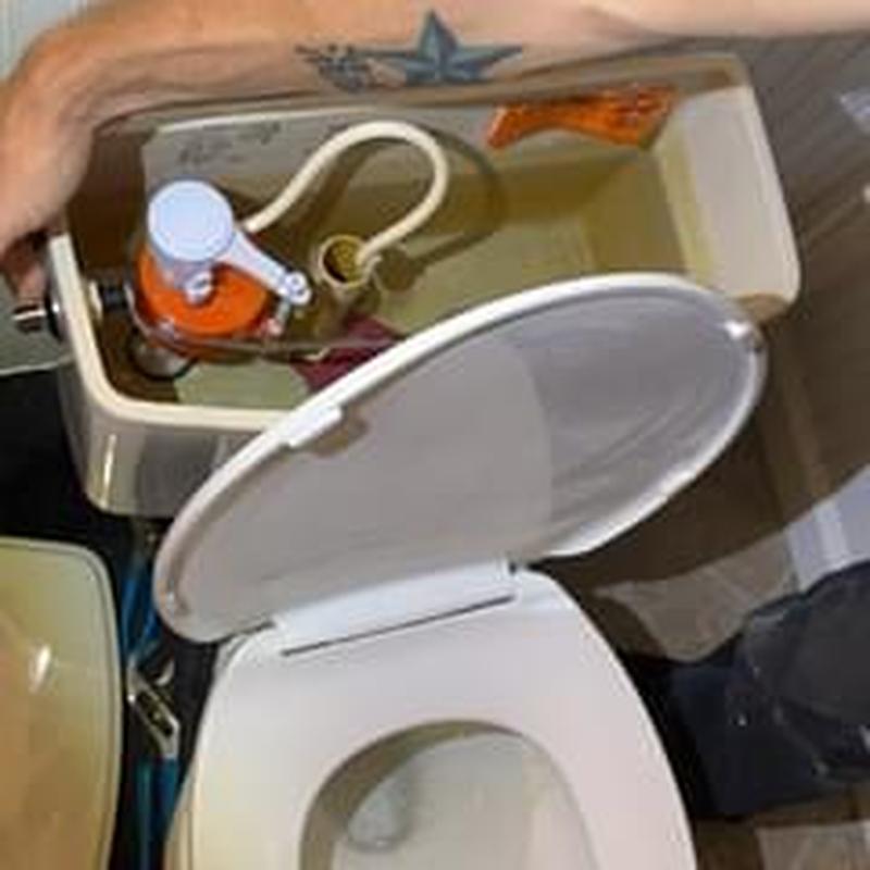 Toilet tank interior with repair parts and open lid