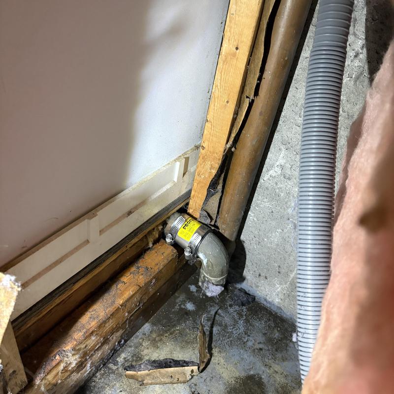 Laundry drain pipe with new elbow fitting in basement