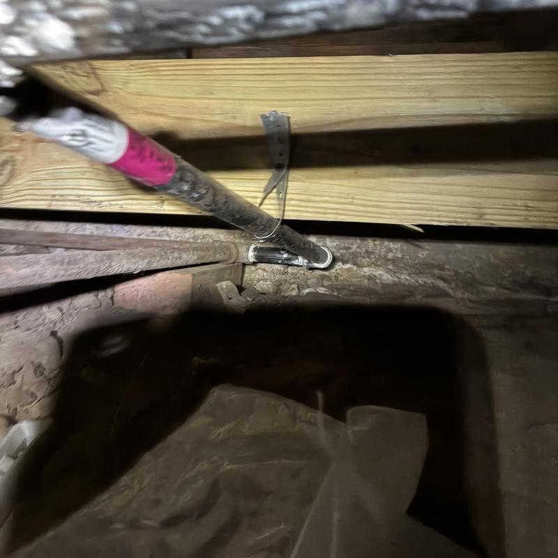 Gas pipe with leak repair under wooden floor beams Gas pipe with leak repair under wooden floor beams