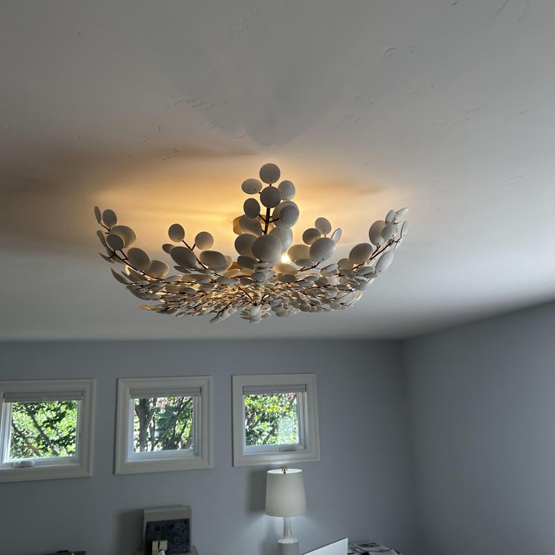 Decorative ceiling light fixture glowing in office room Decorative ceiling light fixture glowing in office room
