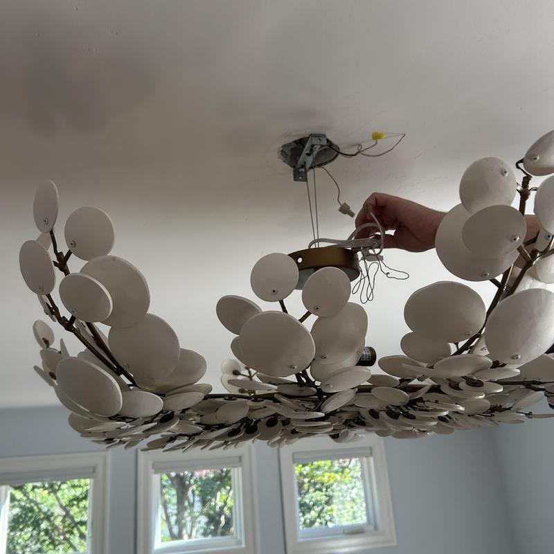 Decorative light fixture being installed on ceiling Decorative light fixture being installed on ceiling
