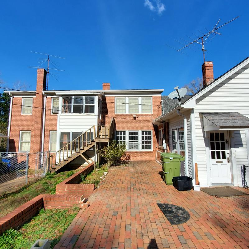 Brick patio with raised garden bed and wooden staircase