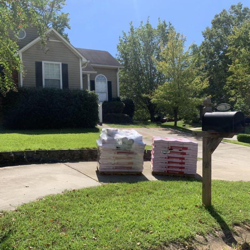 Roof shingles delivery on residential driveway in Columbia SC