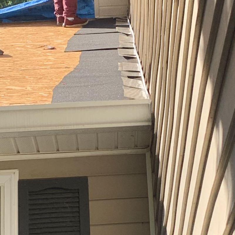 Roof underlayment installation on residential home edge