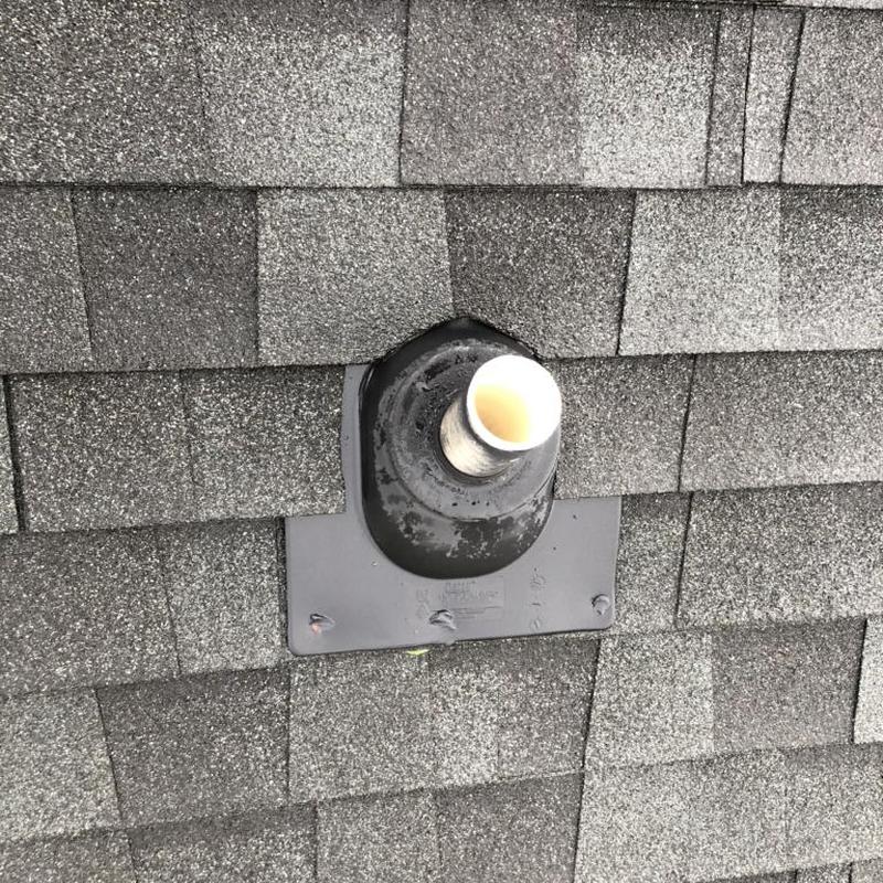 Pipe boot and roof shingles close-up on repair site