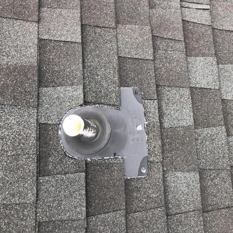 Pipe boot on shingle roof with sealant applied