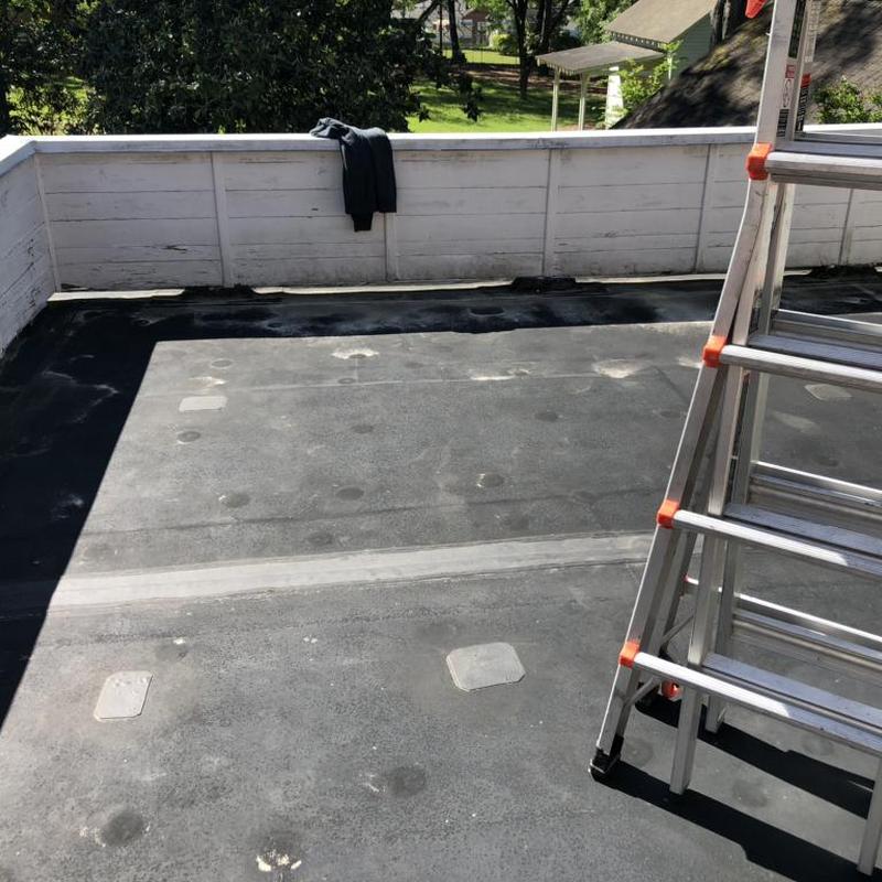 Rubber flat roof with ladder and railing