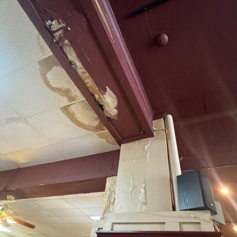 Ceiling tiles with water damage and peeling paint