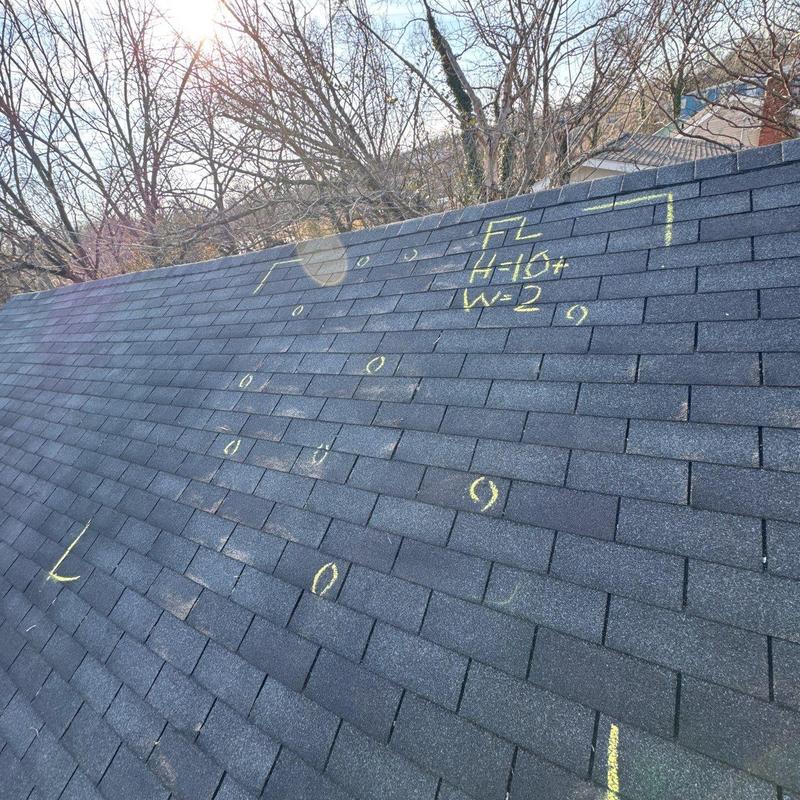 Asphalt shingle roof with hail damage markings