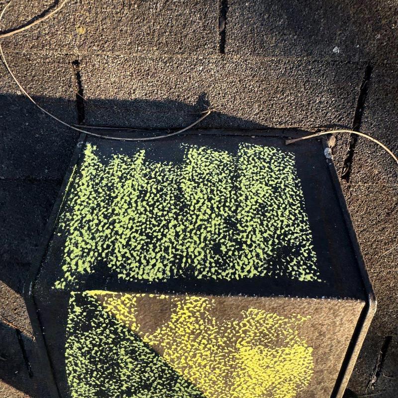 Roof ventilation cap with hail damage markings