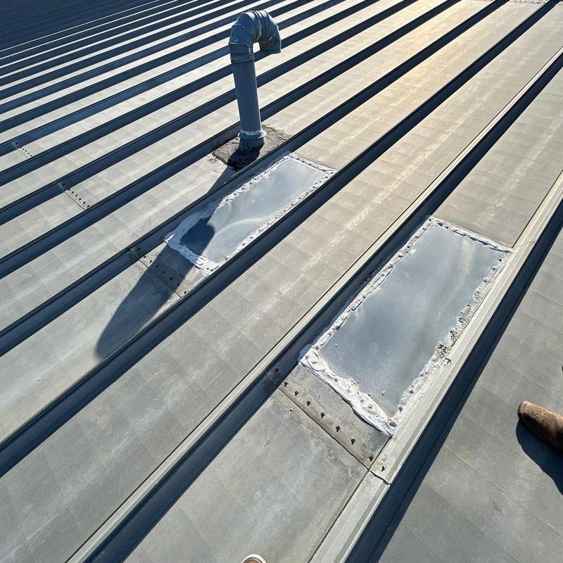 Metal roof patches near vent pipe on standing seam roof