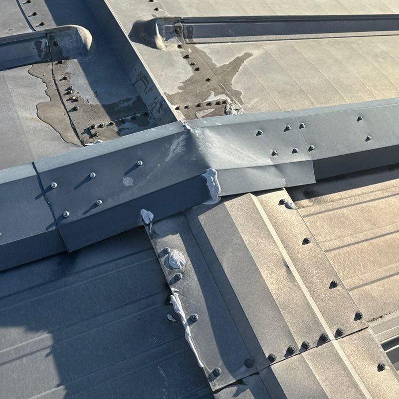 Metal roof lap joints with hail damage and sealant repairs