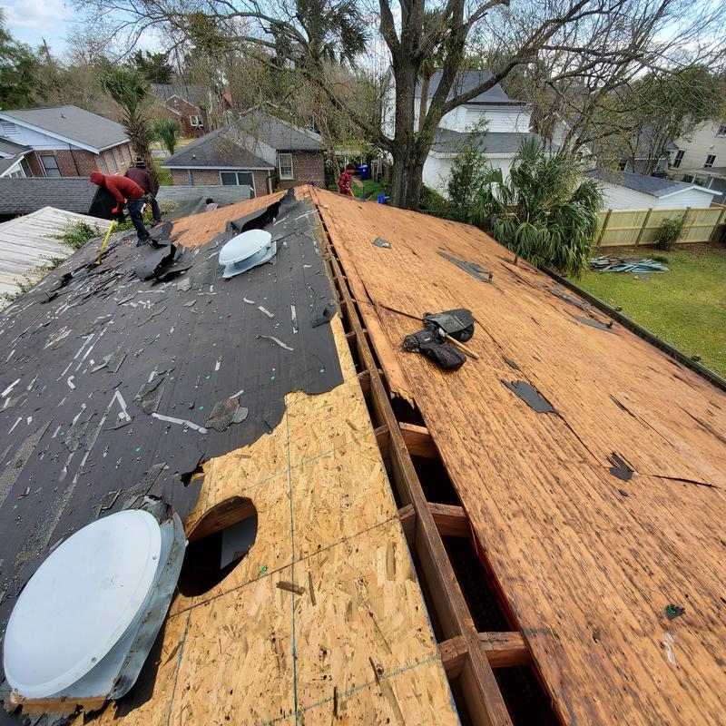 Roof decking removal exposing plywood and OSB panels