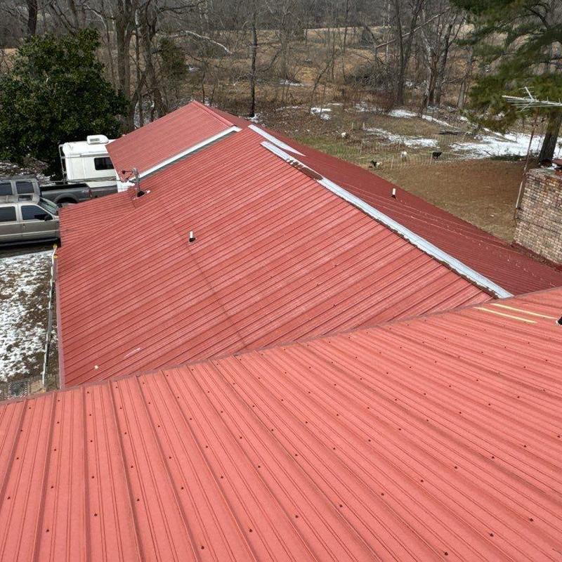 Metal roof panels with hail impact damage and flashing