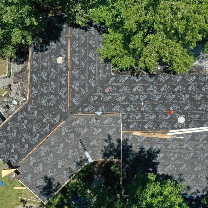 Roof underlayment installation on home after tree damage