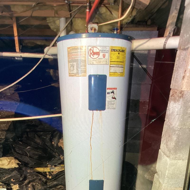 Electric water heater in crawl space with leaking stains Electric water heater in crawl space with leaking stains