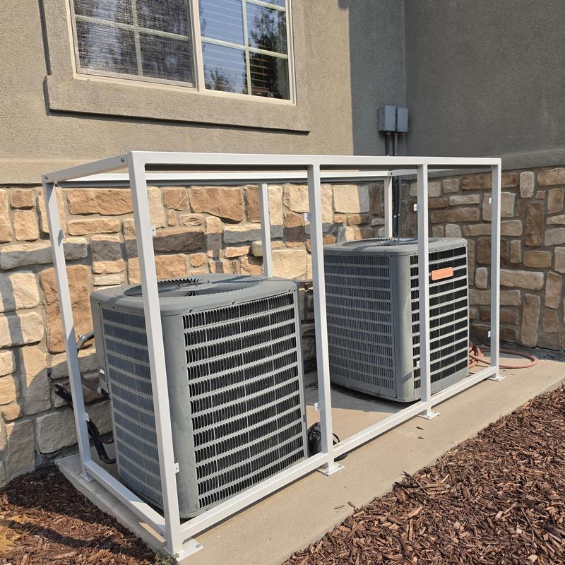 Goodman condenser units with protective cage outdoors