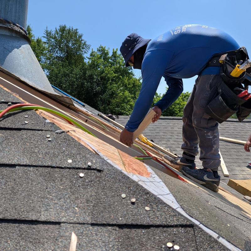 Chimney flashing installation on roof with carpenter
