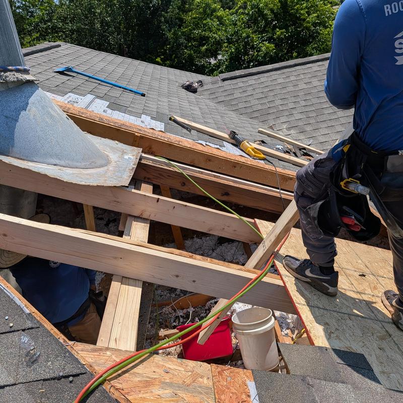Chimney base carpentry framing on roof repair