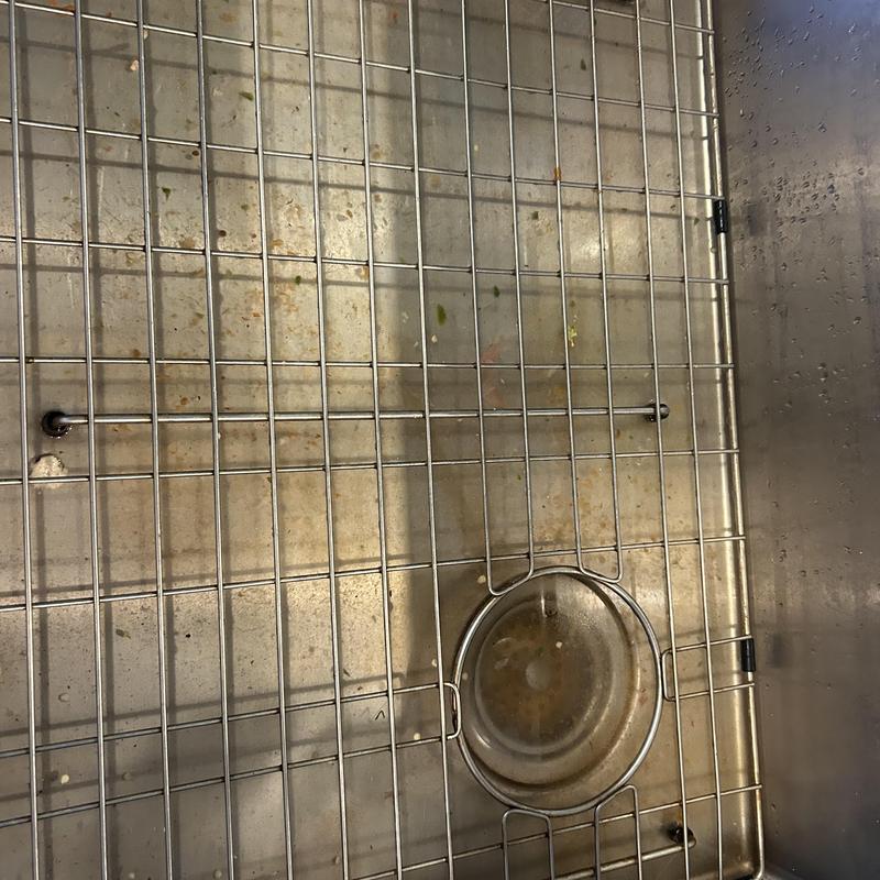 Kitchen sink drain with metal rack and debris Kitchen sink drain with metal rack and debris