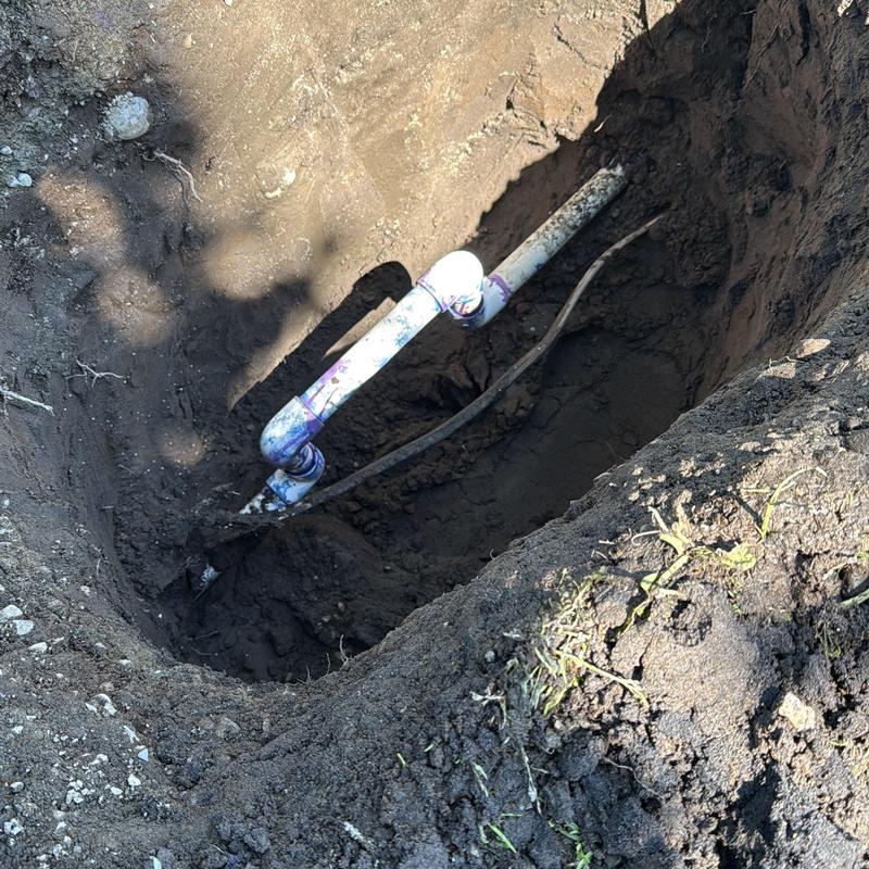 Water service piping excavation and repair trench in dirt Water service piping excavation and repair trench in dirt