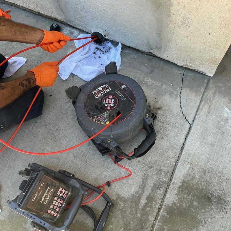 Kitchen branch drain line clearing with drain snake machine