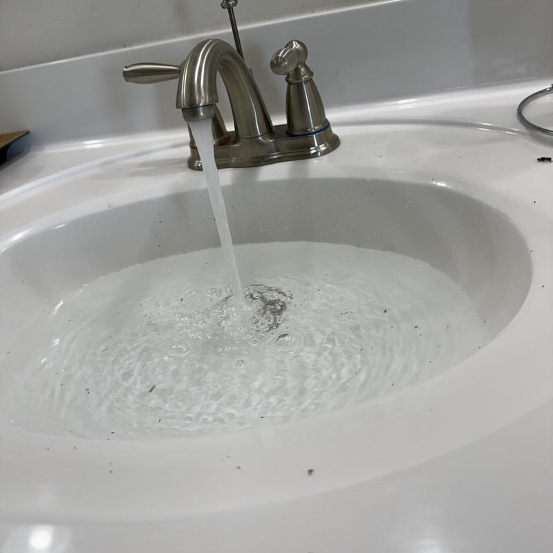 Bathroom sink faucet with running water and pop-up drain