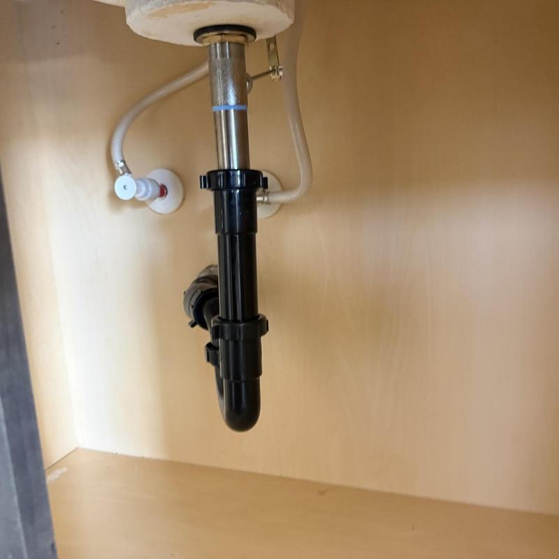 Sink pop-up drain assembly and water supply lines under cabinet