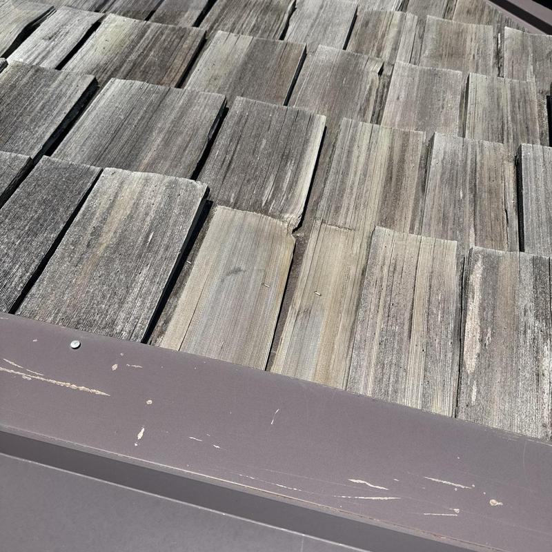 Wood shake roofing inspection with metal flashing detail