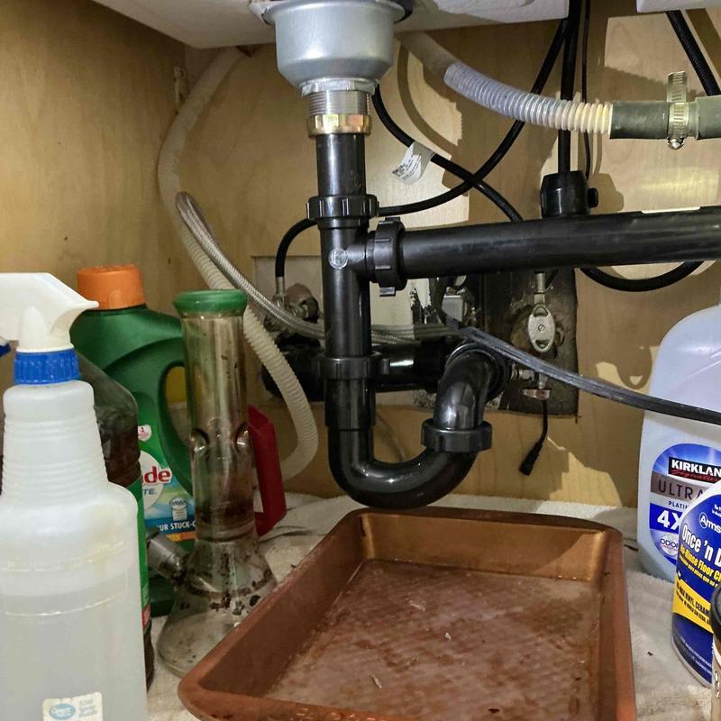 Basket strainer and P-trap plumbing installation under sink