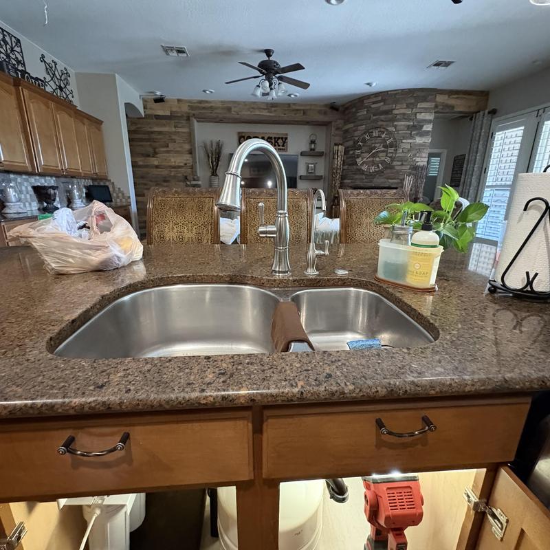 Stainless steel kitchen sink with faucet and soap dispenser