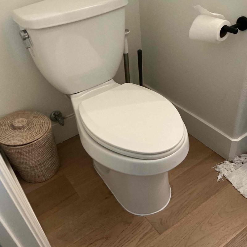 Toilet installation with new wax ring in bathroom