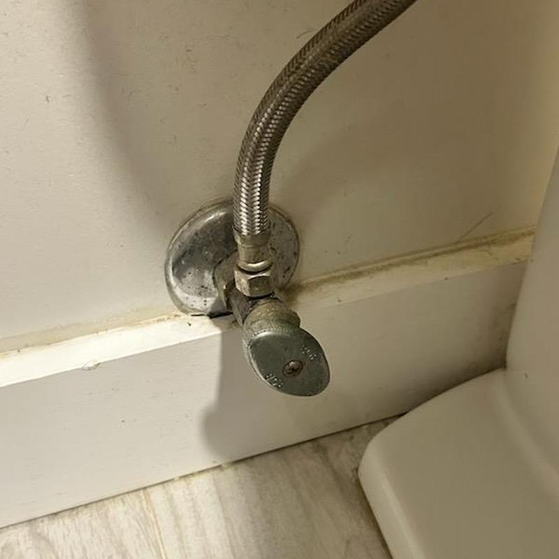 Angle stop valve and flexible water supply line under toilet