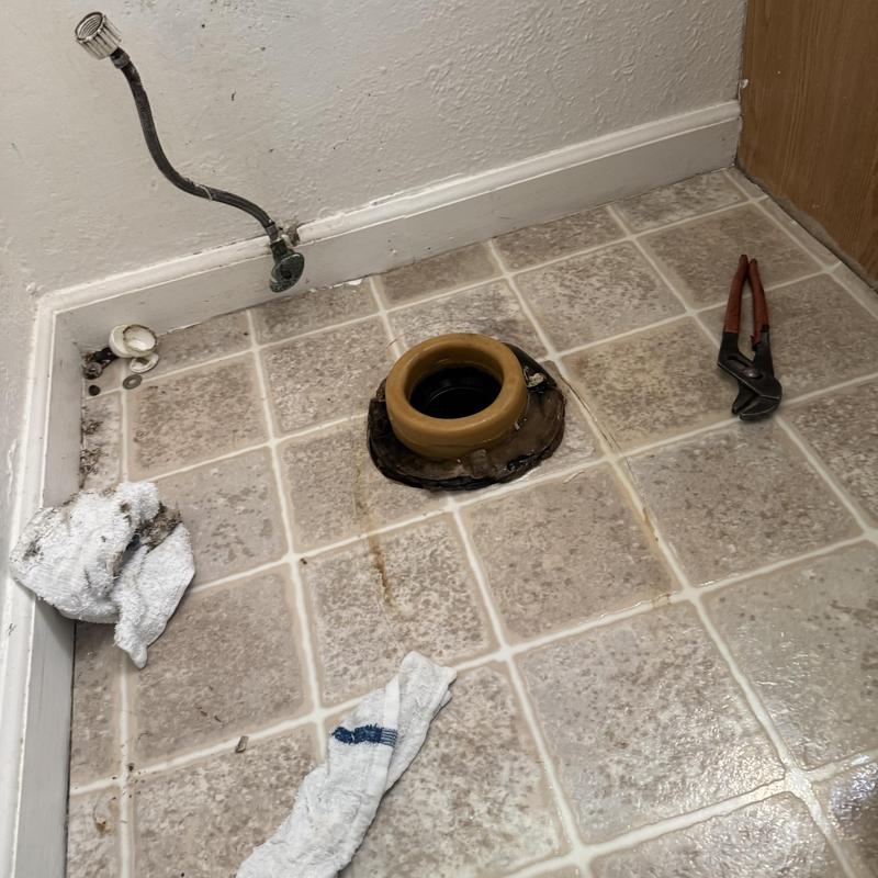 Toilet flange with new wax ring and plumbing tools