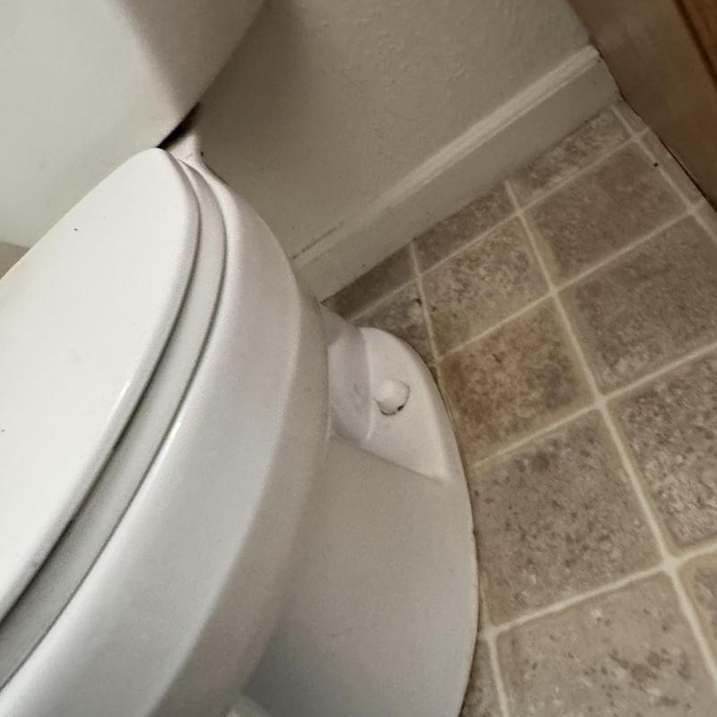 Toilet base and wax ring seal reset on tiled floor