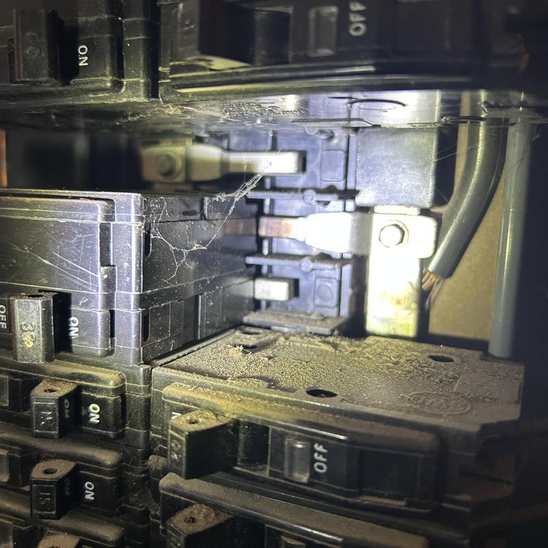 Split bus main service panel with arc marks and dust buildup Split bus main service panel with arc marks and dust buildup