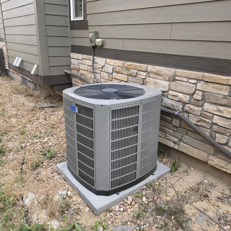 American Standard air conditioner unit outside home