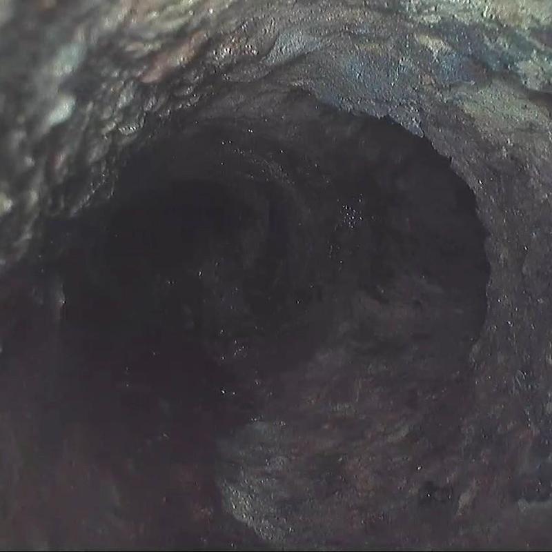 Sewer pipe interior showing a sewer belly dip