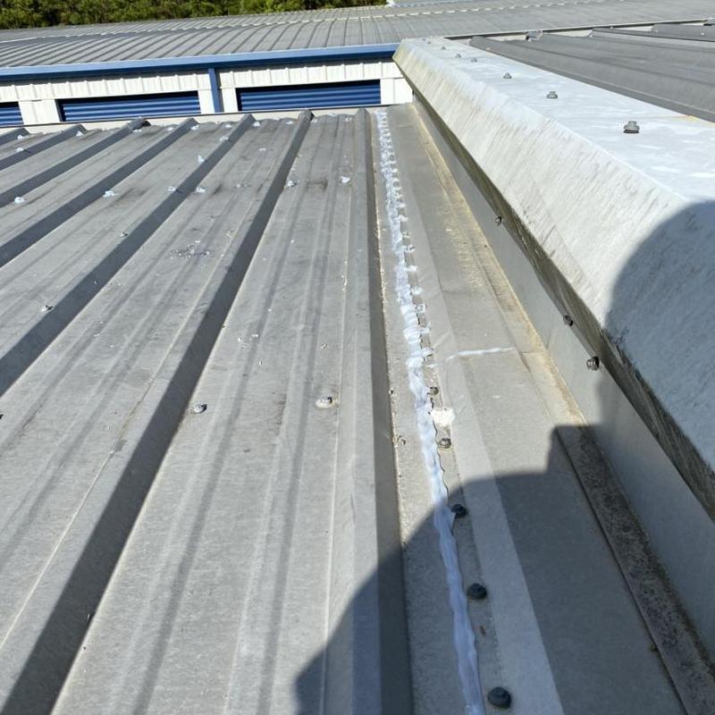 Metal storage unit roof with sealant repairs